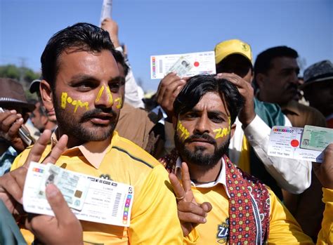 Peshawar Zalmi fans flash their match tickets as they queue up outside ...