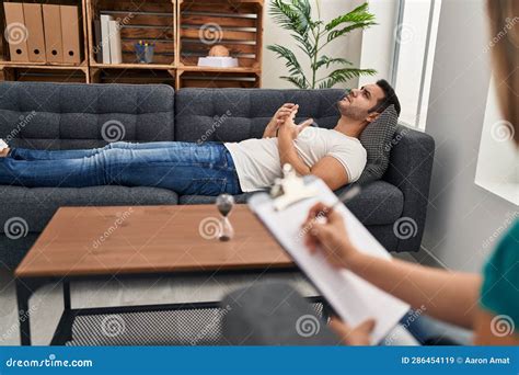 Young Hispanic Man Stressed Having Mental Therapy Lying on Sofa at ...