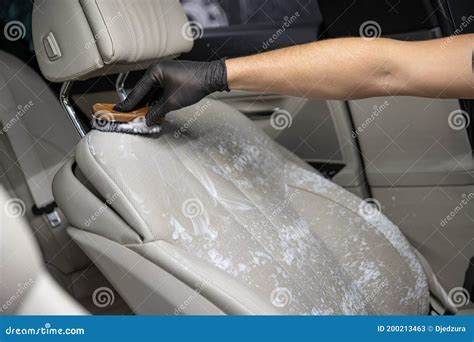 Car Detailing Studio Worker Cleaning Car Interior and Car Leather Seats ...