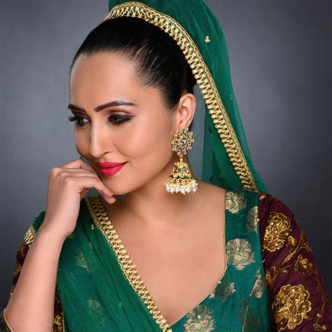 Sukkhi Pretty Kundan Gold Plated Meenakari Jhumki Earring Set Worn By ...