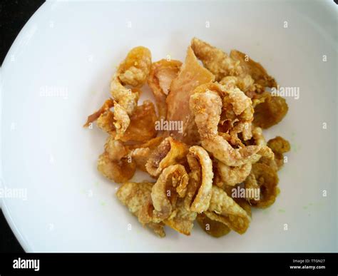Close up of deep-fried chicken skins in a white bowl Stock Photo - Alamy