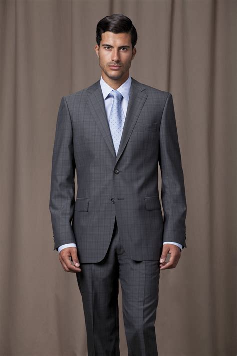 Grey, checked suit with powder blue shirt and matching silk tie ...