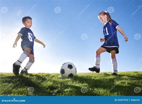 Young Soccer Players Kicking Ball Stock Photo - Image of motion, league ...
