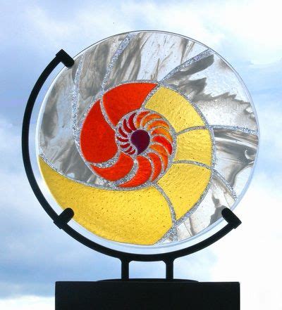 a circular stained glass piece on top of a black stand