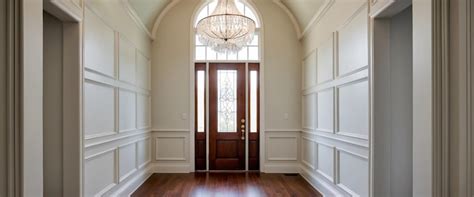 An elegant unfurnished entryway with wainscoting and a stunning ...
