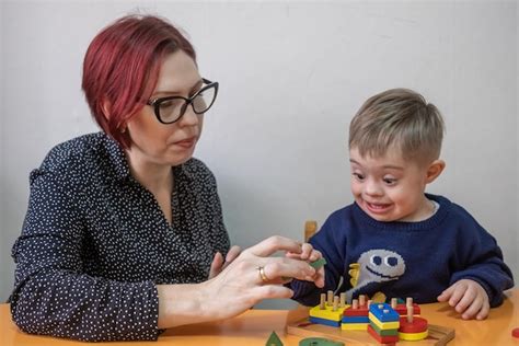 Child living with down syndrome playin learning game with educational ...