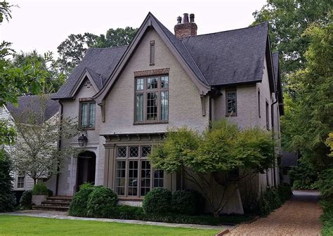 Tudor-Revival Home with Painted Brick and Arched Entry