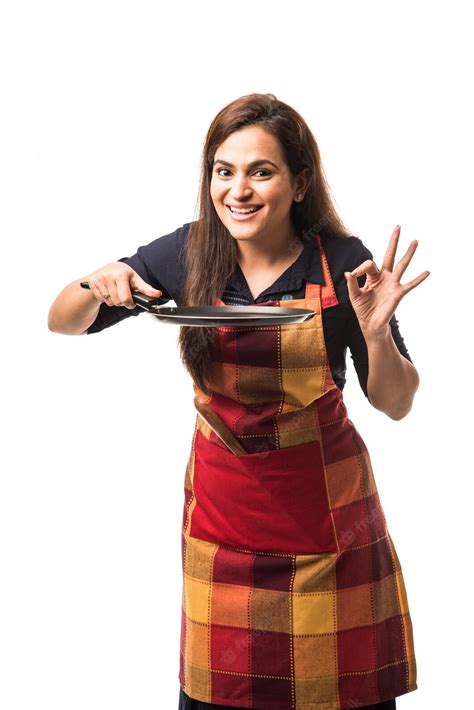 Indian or asian woman chef wearing apron and holding pan and spatula ...
