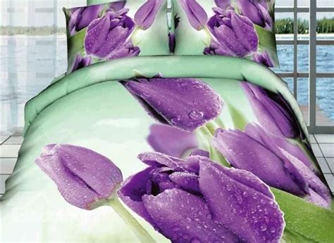 a bed with purple flowers and water droplets on it