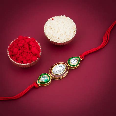 Sukkhi Gleaming Gold Plated Oval Meenakari Rakhi with Roli Chawal and ...