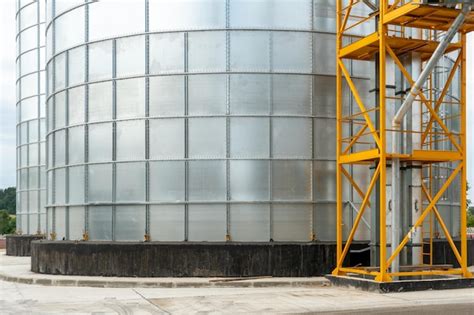 Silver silos on agro manufacturing plant for processing drying cleaning ...