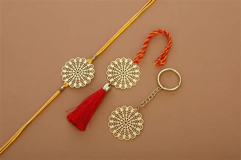 Floral design Rakhi for bhabhi with red hanging tassel cum keychain ri ...