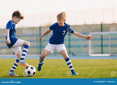 Two Junior Soccer Players Training with Soccer Ball on Stadium Grass ...