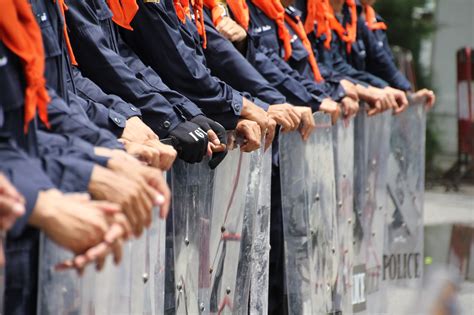 Stock photo 150369734 - Hands of riot police holding shields, standing ...
