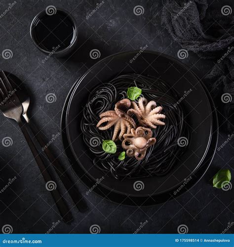 Squid Ink Spaghetti Pasta with Octopuses in Black Bowl Stock Photo ...