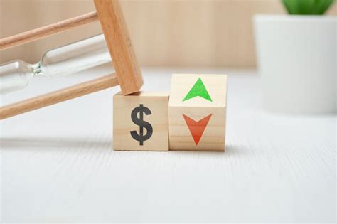 Wooden blocks with us dollar sign and up and down arrows. | Premium Photo