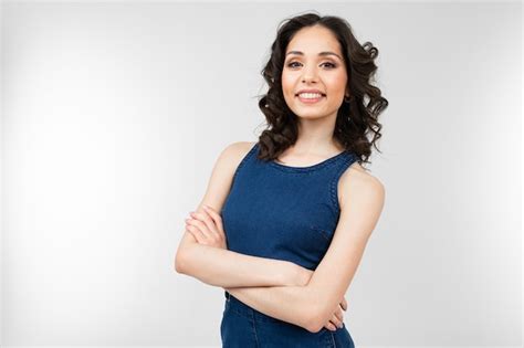 Girl in summer blue overalls posing on a white background. | Premium Photo
