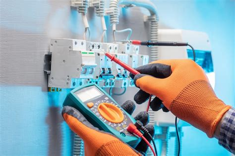 Electrician work tester measuring voltage in fuse board electrical ...