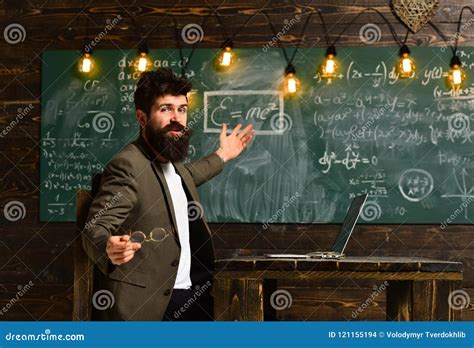 Pretty Teacher Helping Pupil in Classroom at the Elementary School, Tutor Asks the Tutee To Find ...