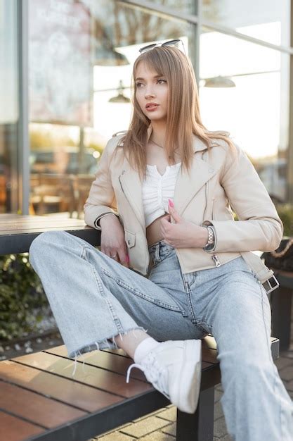 Stylish pretty young caucasian woman in urban streetwear with leather ...