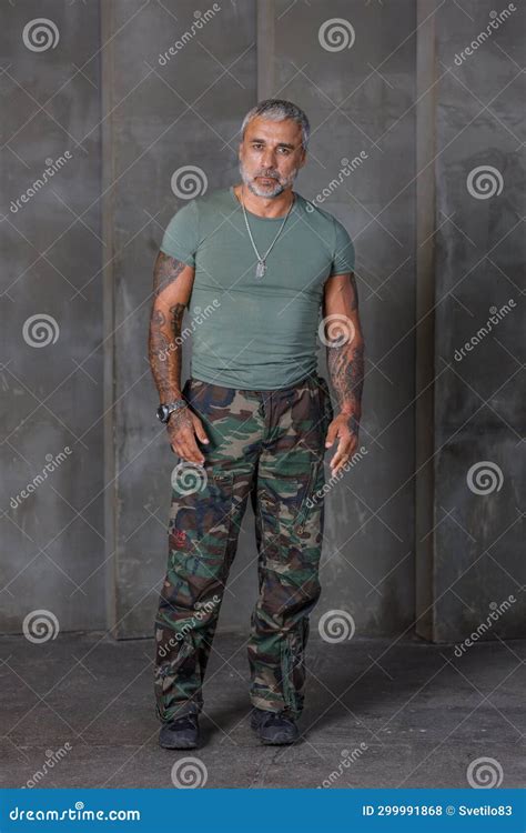 A Soldier in Camouflage, a Soldier Stands Against the Wall.a Mature ...
