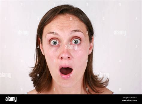 Young brunette woman with shocked surprised stunned aghast amazed ...