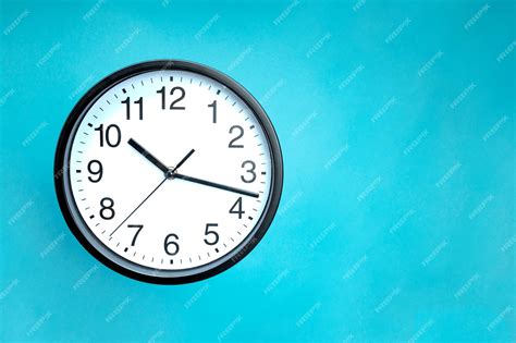 Premium Photo | Classic black and white analog clock on a blue ...