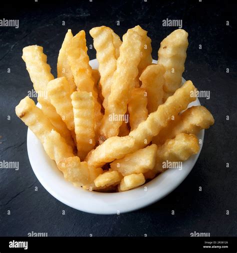 Crinkle cut french fried potatoes Stock Photo - Alamy