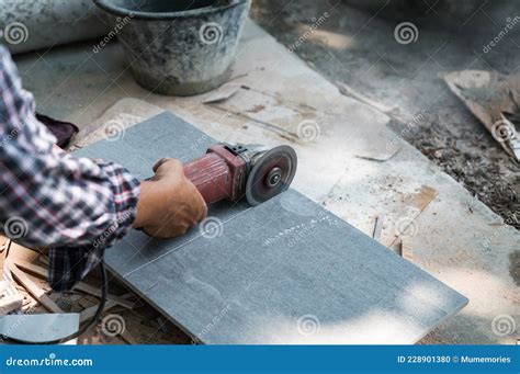 Worker Using Electric Circular Saw Cutting Tile in Construction Site ...