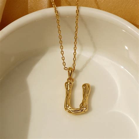 Buy Pipa Bella by Nykaa Fashion Gold & Black Textured U Initial Pendant ...