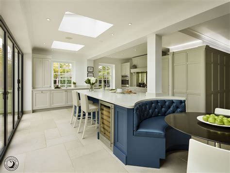 The curved banquette bench seat at one end of the island forms a ...