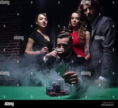Rich handsome man smoking cigar and playing in the casino Stock Photo ...