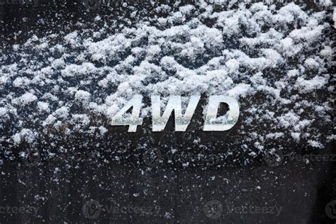 an abbreviation 4wd - Four-wheel drive - on dirty black car back 12639805 Stock Photo at Vecteezy