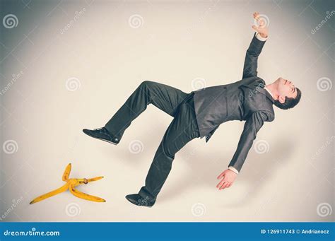 Businessman Slipping and Falling from a Banana Peel Stock Image - Image ...