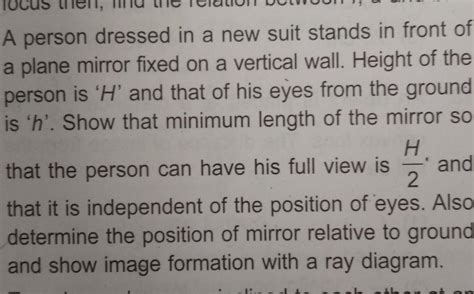 A person dressed in a new suit stands in front ofa plane mirror fixed ...