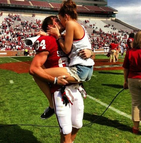 football player kissing his girlfriend