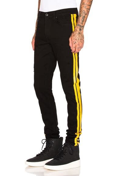 Amiri Stack Track Jean in Black & Yellow | FWRD