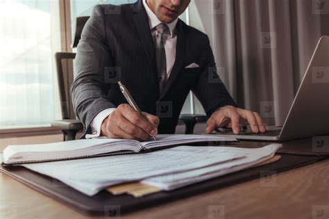 Businessman Working at Desk 的图像结果