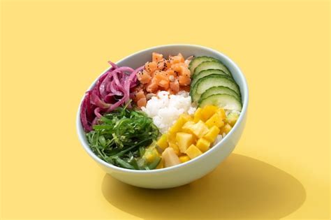 Poke bowl with rice salmoncucumbermangoonionwakame salad poppy seeds ...