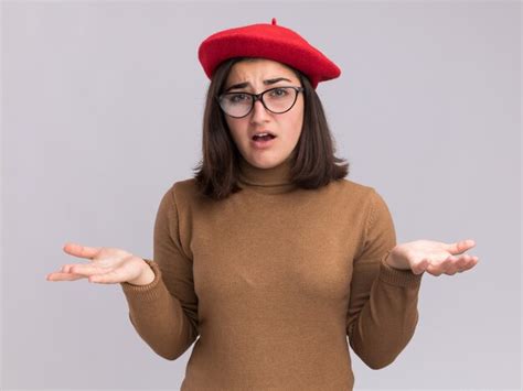 Clueless young pretty caucasian girl with beret hat and in optical ...