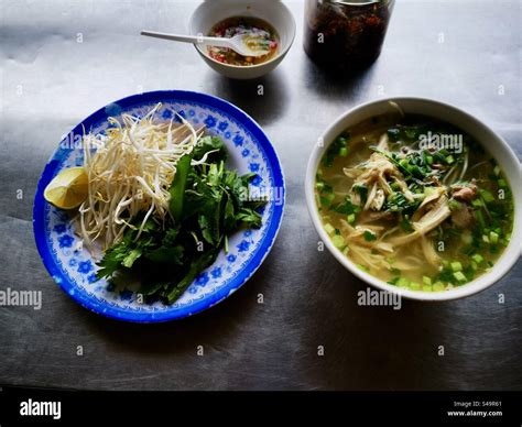 Vietnamese Pho soup with herbs and chili sauce Stock Photo - Alamy