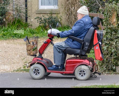 Mobility scooter - Electric mobility scooter being ridden by an elderly ...