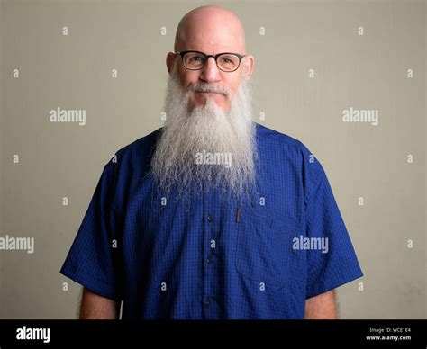 Mature bearded bald man with mustache wearing eyeglasses Stock Photo ...