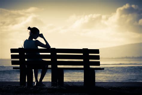 Lonely woman sitting alone on a bench - MGH Center for Women's Mental Health