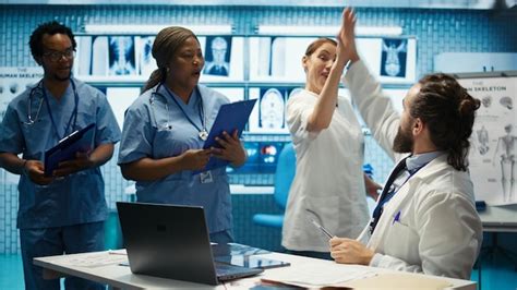 Happy team of medics sharing a high five after successful research ...