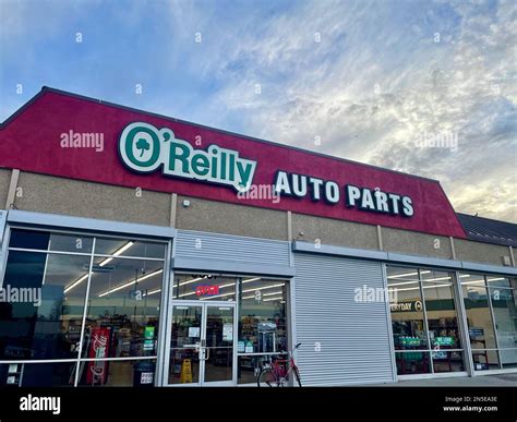 The entrance of the O'Reilly Auto Parts store against the blue cloudy ...