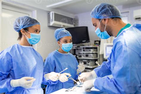 Diverse Team of Professional surgeon, Assistants and Nurses Performing Invasive Surgery on a ...