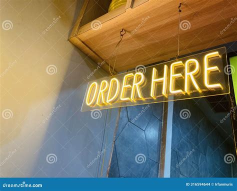 Glowing Order Here Sign Hanging on the Ceiling Stock Photo - Image of ...