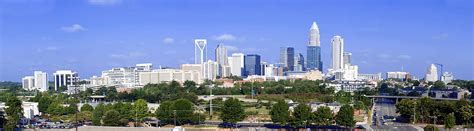 Charlotte skyline featuring modern skyscrapers and greenery, representing North Carolina's urban landscape for managed IT services.