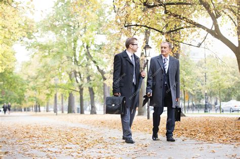 Two Business People Walking Side by Side 的图像结果